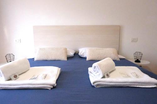 a bedroom with two beds with towels on them at Casa Segantini - Relax Apartment 2 in Arco