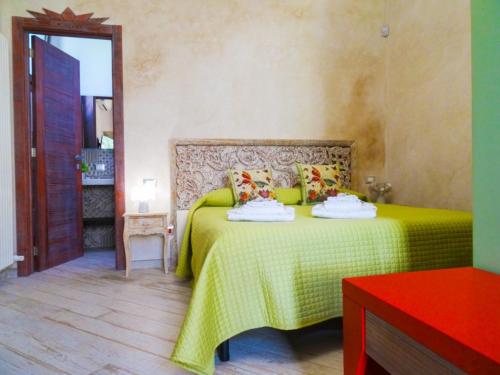 a bedroom with a bed with a yellow bedspread at Biancolivo Gallipoli in Salento in Gallipoli