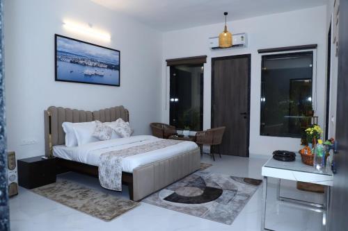 a bedroom with a bed and a table and a desk at Nesara the nature villa in Jāmb