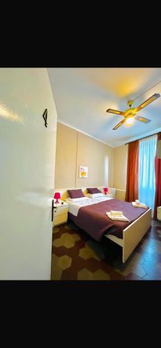 a bedroom with a bed and a ceiling fan at La Locanda Del Viandante in Bellano