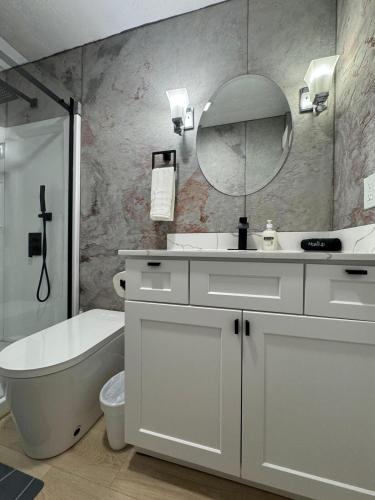 a bathroom with a sink and a tub and a mirror at Cozy blue house in Salt Lake City