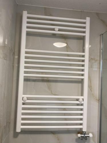 a white shelf in a bathroom with a sink at Sarakinas Farm House in Kalabaka