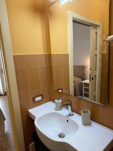 a bathroom with a white sink and a mirror at Biancolivo Gallipoli in Salento in Gallipoli