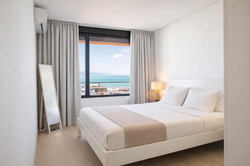 a bedroom with a bed and a large window at Nogalera Sea View Luxe in Torremolinos