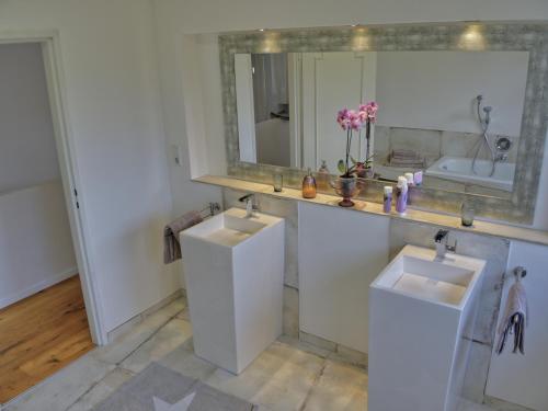 a bathroom with two sinks and a mirror at Rheinvilla Weitblick in Boppard