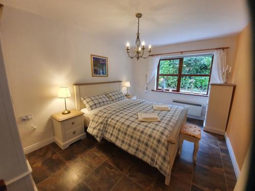 a bedroom with a bed and a window at An Cnocan in Sneem