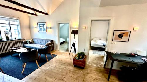 a living room with a couch and a room with a bed at The Viking s Haven - Heart of Downtown in Reykjavík