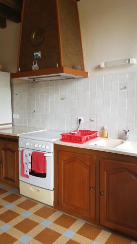 a kitchen with a stove and a sink at Gite à Lulu in Châteauvieux