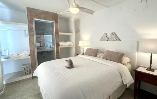 a bedroom with a white bed with a stuffed animal on it at STARBAL in Es Castell