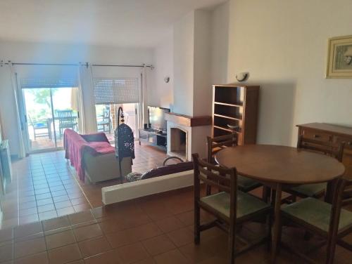 a living room with a table and a dining room at Belver Porto Dona Maria Resort in Luz