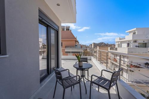 a balcony with a table and chairs and a view at Athens Vein in Athens