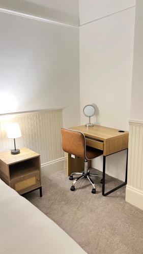 an office with a desk and a chair and a lamp at Modern Spacious 4 Bedroom Home in Greater LDN With Garden and Parking in Dartford