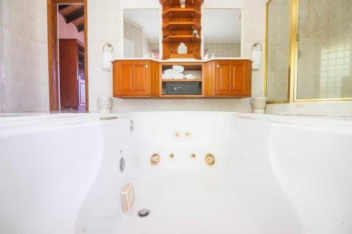 a bathroom with a sink and a microwave at forst home with a great ocean view in Kingstown