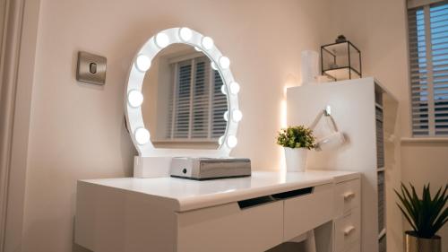 a white dressing table with a mirror on a wall at Margate Duplex with Private Terrace Air Conditioning The Duplex Margate in Margate