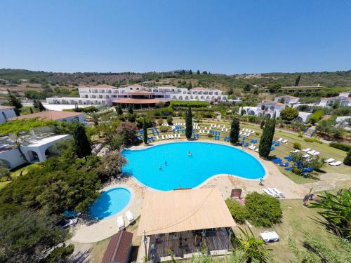 an aerial view of a resort with a swimming pool at Sunrise Village Beach Hotel in Kalamaki Messinia