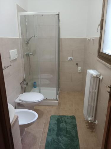 a bathroom with a shower and a toilet and a sink at Fashion room in Altamura