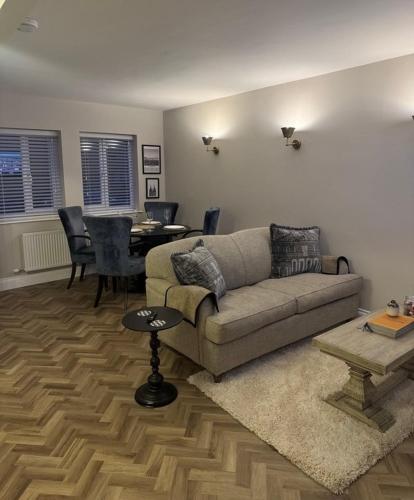 a living room with a couch and a table at Entire Flat in Lichfield City Centre in Lichfield