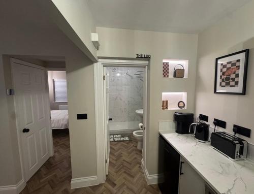 a bathroom with a sink and a toilet in a room at Entire Flat in Lichfield City Centre in Lichfield