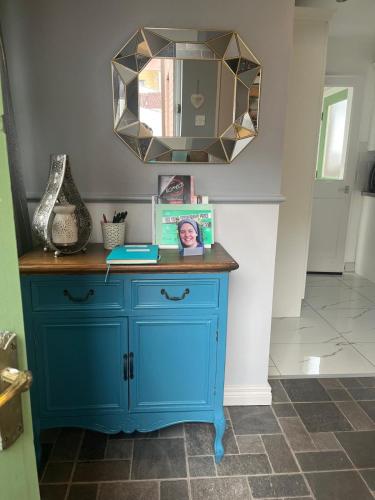a blue dresser with a mirror on top of it at Cierons château in Derry Londonderry