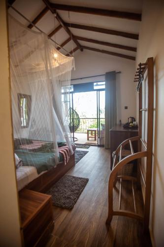 a bedroom with a bed with a mosquito net at Slon Ella in Ella
