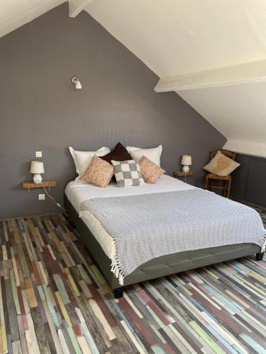 a bedroom with a bed with pillows on it at Le Fort Vauban in Ambleteuse