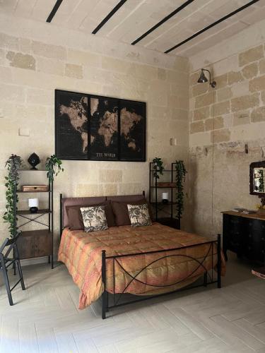 a bedroom with a bed in a brick wall at ITALY Home 16 in Grottaglie