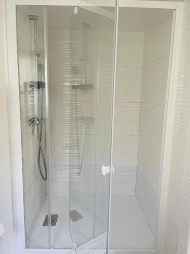 a shower with a glass door in a bathroom at Le Fort Vauban in Ambleteuse