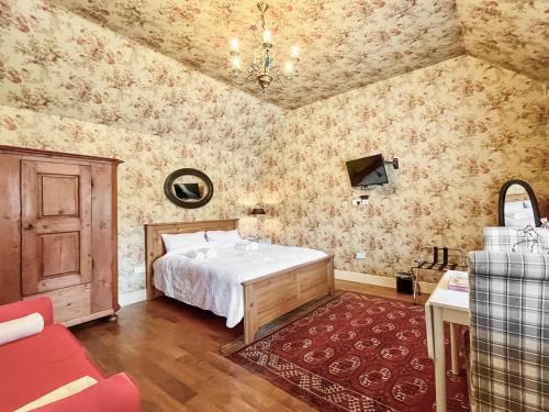 a bedroom with a bed in a room with wallpaper at Cottage 2 - Uk46612 in Broughton