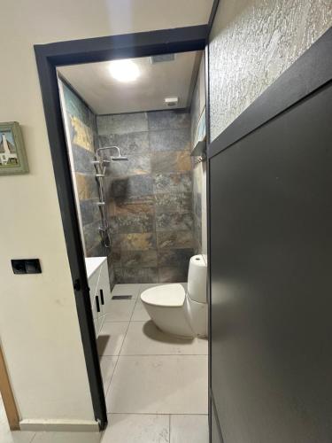 a bathroom with a toilet and a walk in shower at Apprt Saidia berqia in Saïdia