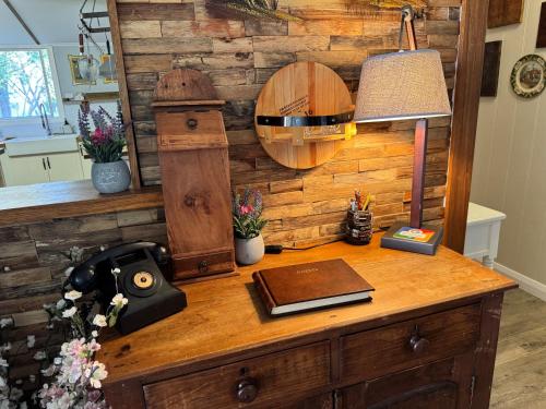 a desk with a lamp and a book on it at Allview Escape Blackheath in Blackheath