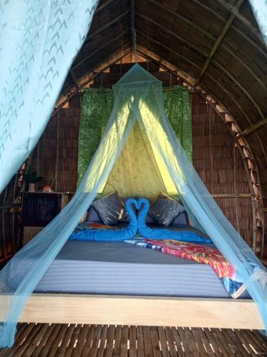 a bed in a igloo with a tent at Tress Maria's beach resort in Brother Islands