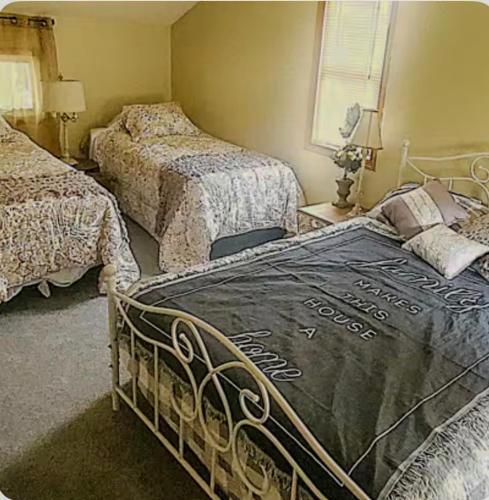 a bedroom with two beds and a bedspread on it at The Hideaway in North Canton