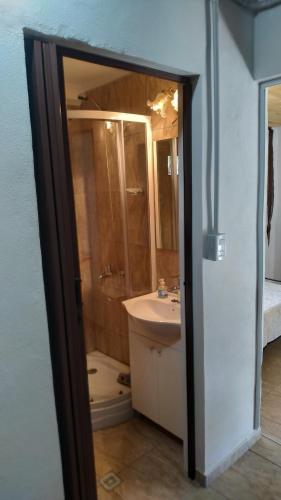 a bathroom with a sink and a shower and a toilet at Ohana in Potrero de Garay