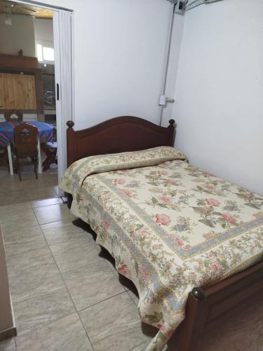 a bed with a quilt on it in a bedroom at Ohana in Potrero de Garay