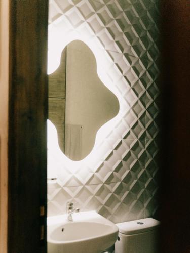 a bathroom with a sink and a mirror at Mish Mish in Tamraght Ouzdar