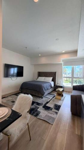 a bedroom with a bed and a couch at Luxury Walk of Fame Studio in Los Angeles