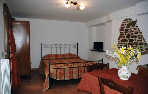 a bedroom with a bed and a vase of flowers on a table at Casale il Colle Deruta in Deruta