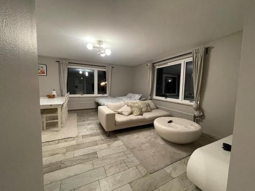a living room with a couch and a table at Siam Homestay in Mölndal
