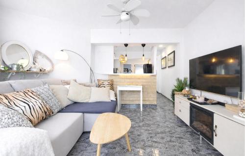 a white living room with a couch and a table at Marisol Molina in Sueca
