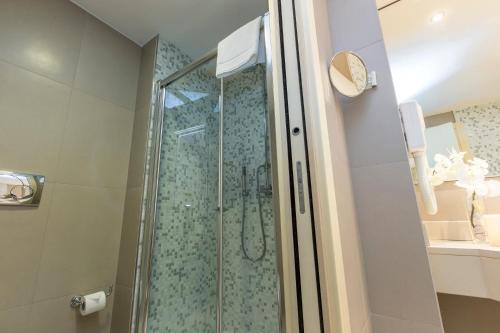 a shower with a glass door in a bathroom at Just Hotel Lomazzo Fiera in Lomazzo