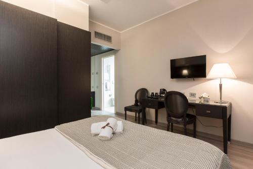 a hotel room with a bed with a desk and a computer at Just Hotel Lomazzo Fiera in Lomazzo