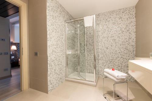 a shower in a bathroom with a glass shower stall at Just Hotel Lomazzo Fiera in Lomazzo