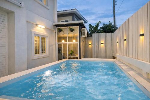 a swimming pool in the backyard of a house at Baan Hug Ubon - Private Pool Villa - Pet Friendly - 2 km from Charoen Sri Fresh Market in Ubon Ratchathani
