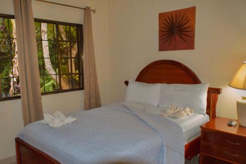 a bedroom with a bed with towels on it at Apart Hotel Acuarious de Luis in Estelí