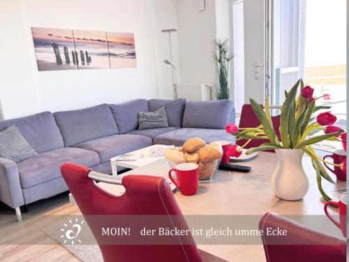 a living room with a couch and a table at Penthouse de Ool Blick auf das Wattenmeer in Neufeld