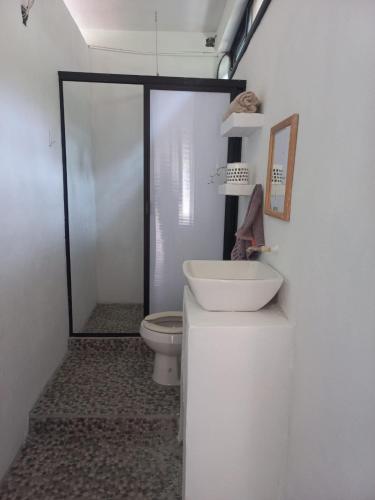 a bathroom with a toilet and a sink at Estudio La Higuera in Yelapa
