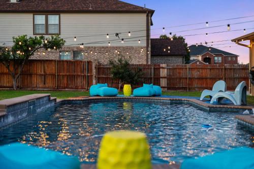 a backyard swimming pool with blue inflatables in a yard at Grand 6BR 3BA Pool Escape Round Rock in Round Rock