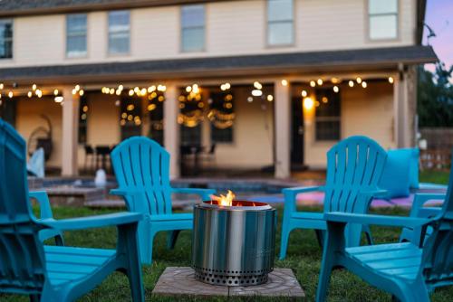 a fire pit in the middle of a yard with chairs at Grand 6BR 3BA Pool Escape Round Rock in Round Rock