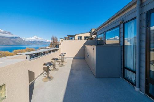 a balcony of a building with a view of the water at Lakefront Luxury Penthouse central Queenstown in Queenstown