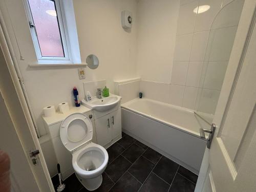 a bathroom with a toilet and a sink and a tub at Doncaster City Centre Immaculate 1 Bedroom flat in Doncaster
